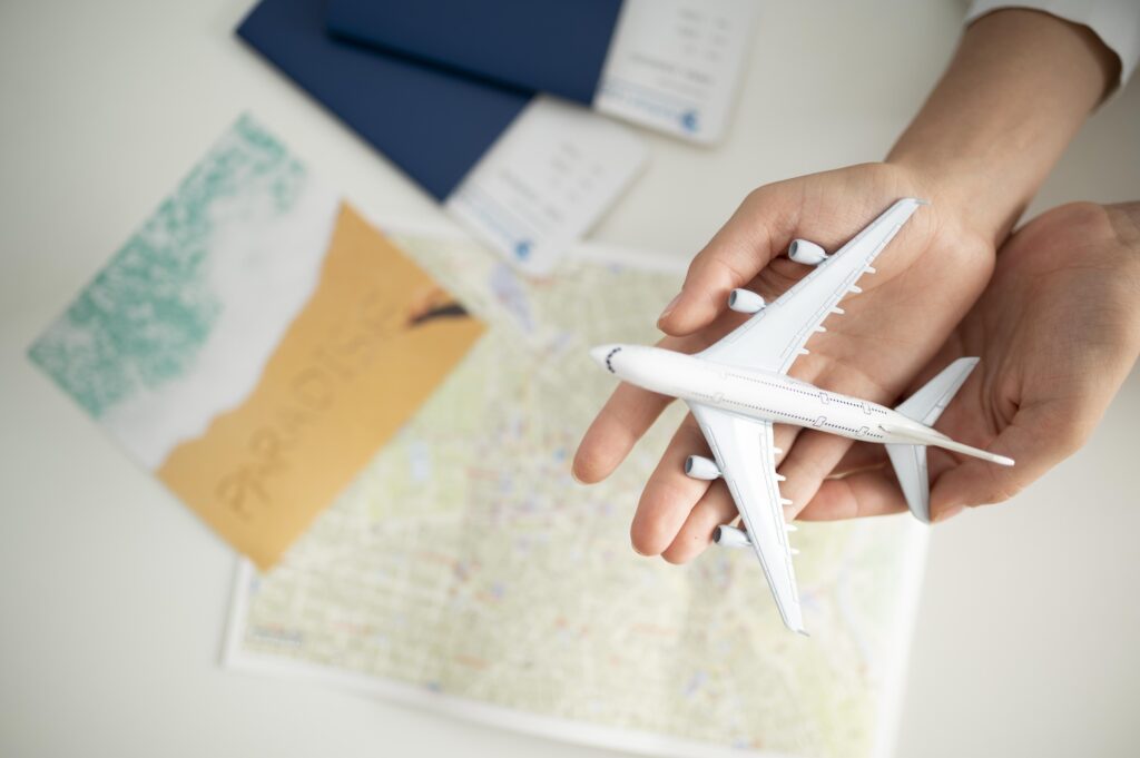 close-up-hands-holding-small-plane-top-view